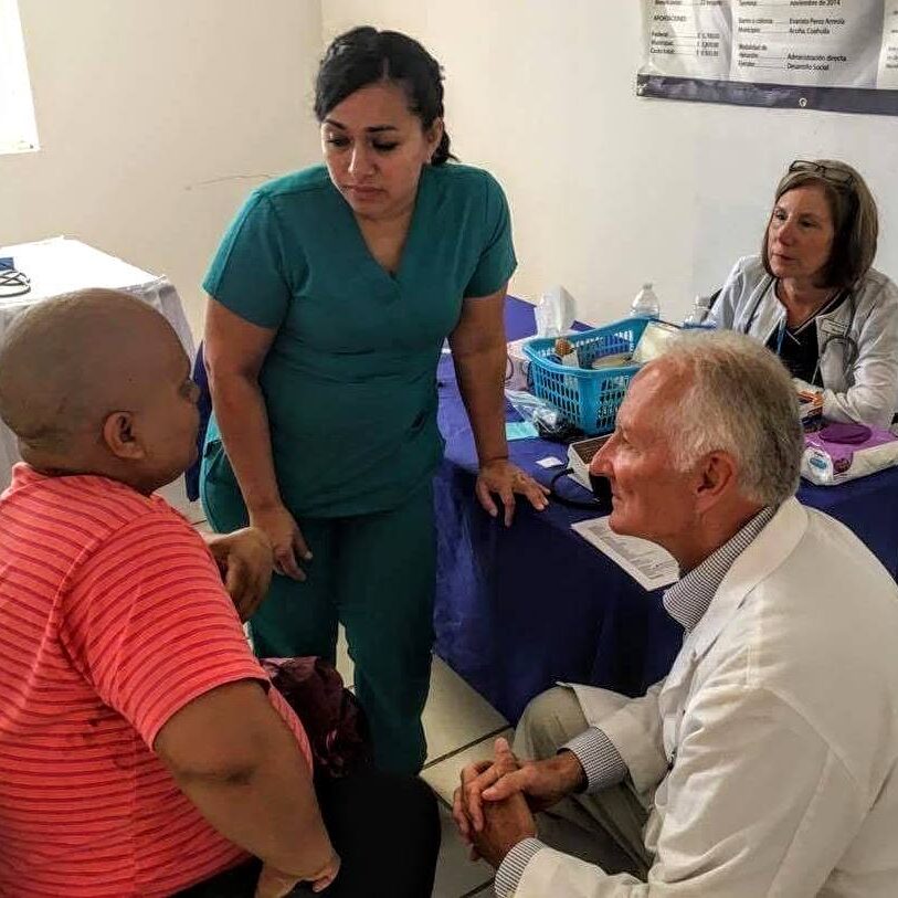AMO volunteer Dr. Johnson seeing cancer patient. AMO volunteer Gabby interpreting for Dr. Johnson.