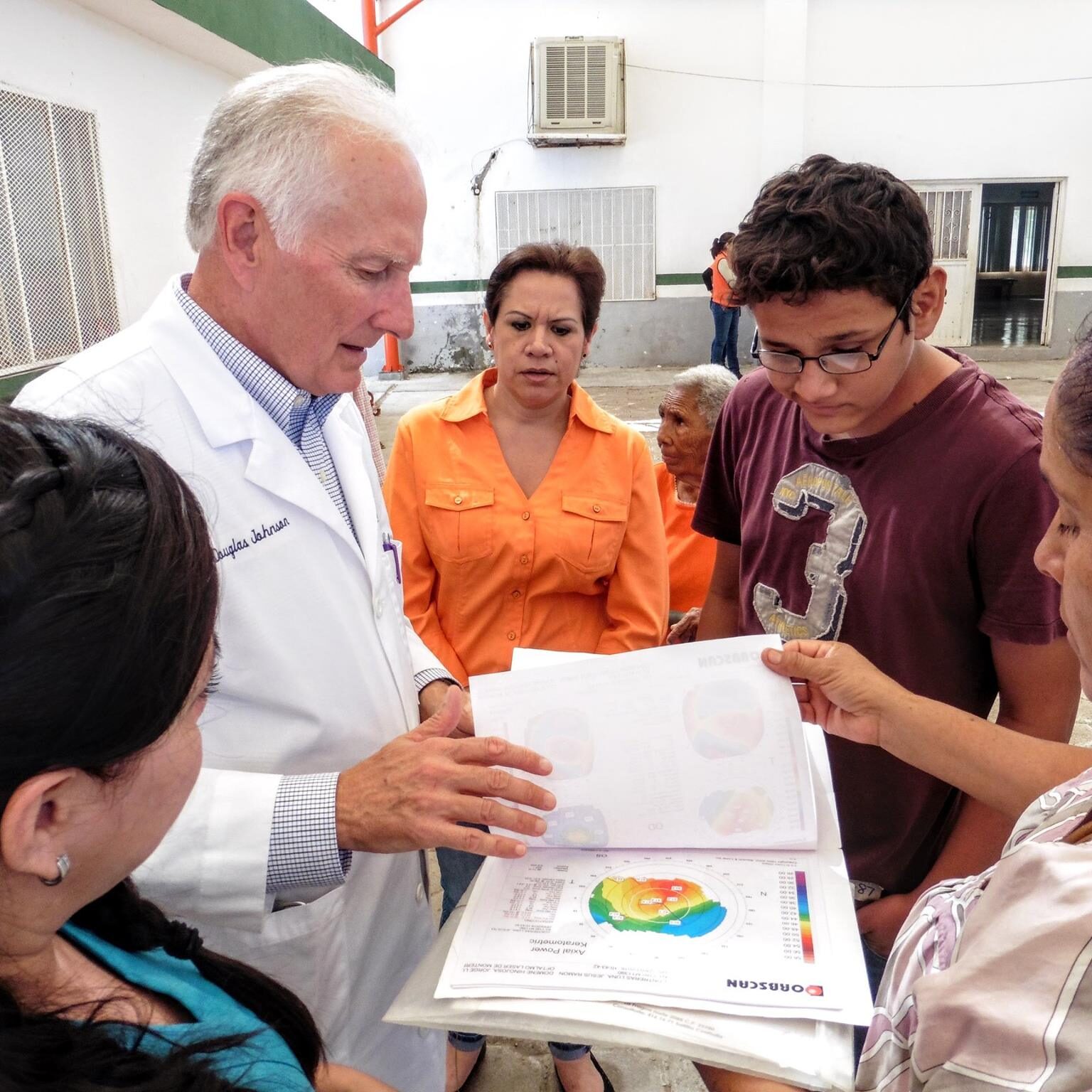 Dr. Johnson helping Jesus and family.